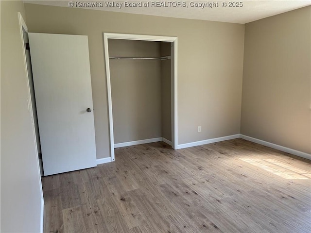1651 Glenwood Rd, Milton, WV 25541 - unfurnished bedroom with baseboards, a closet, and wood finished floors