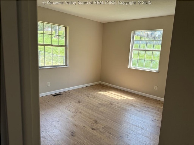 1651 Glenwood Rd, Milton, WV 25541 - spare room with visible vents, baseboards, and hardwood / wood-style floors
