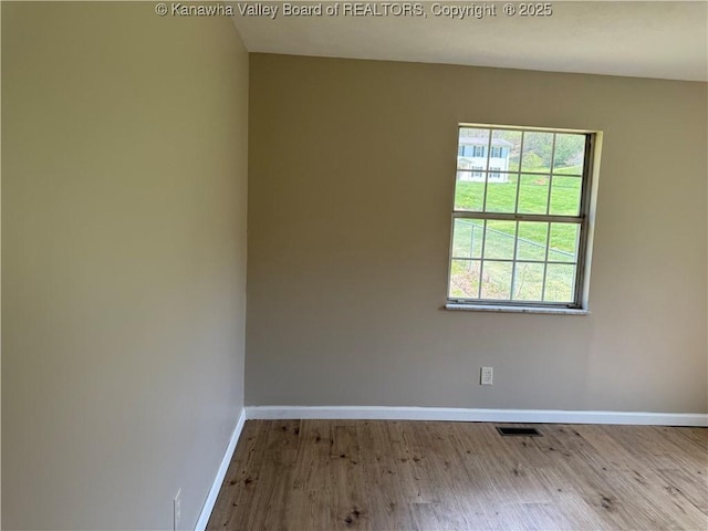 1651 Glenwood Rd, Milton, WV 25541 - unfurnished room featuring baseboards, visible vents, and wood finished floors