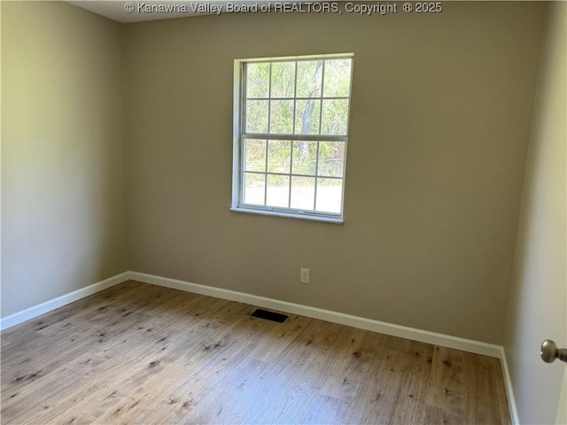 1651 Glenwood Rd, Milton, WV 25541 - unfurnished room featuring baseboards, visible vents, and wood finished floors