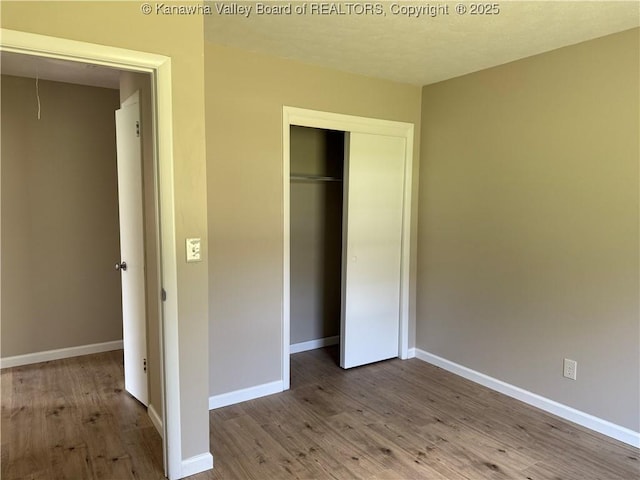 1651 Glenwood Rd, Milton, WV 25541 - unfurnished bedroom featuring a closet, wood finished floors, and baseboards