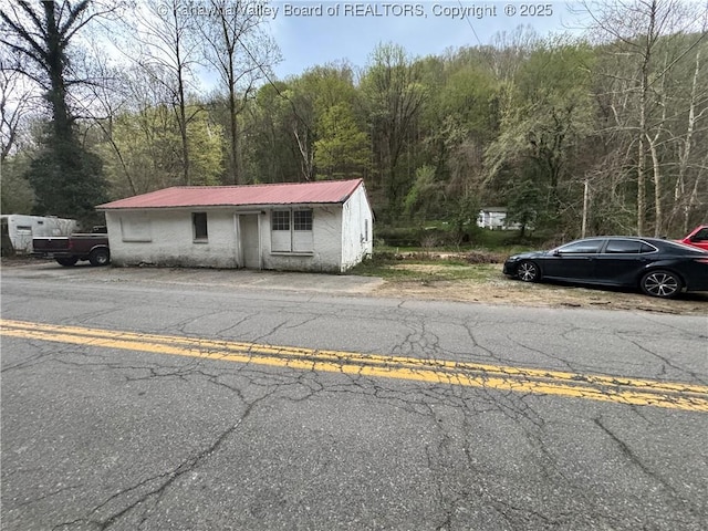 5806 Kanawha State Forest Dr, Charleston, WV 25314 - view of front of house with a view of trees and metal roof