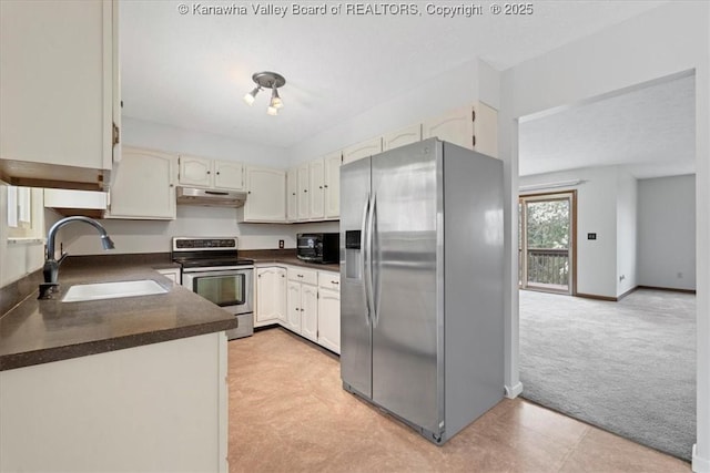 141 Wedgewood Rd, Ravenswood, WV 26164 - kitchen with a sink, dark countertops, under cabinet range hood, stainless steel appliances, and light colored carpet