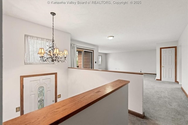 141 Wedgewood Rd, Ravenswood, WV 26164 - corridor featuring a chandelier, an upstairs landing, baseboards, and carpet floors