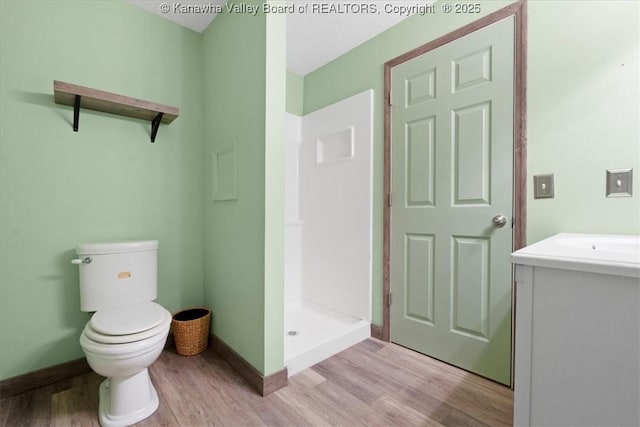 141 Wedgewood Rd, Ravenswood, WV 26164 - full bathroom with vanity, baseboards, toilet, a shower stall, and wood finished floors