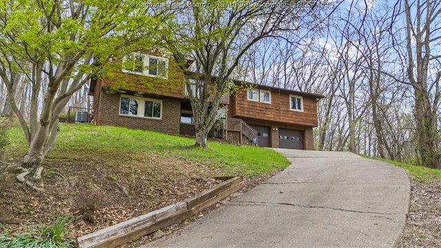 141 Wedgewood Rd, Ravenswood, WV 26164 - view of front of home with brick siding, a front yard, driveway, and a garage