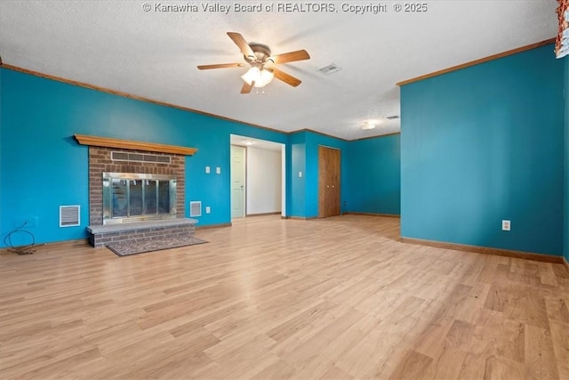 141 Wedgewood Rd, Ravenswood, WV 26164 - unfurnished living room with a fireplace, a textured ceiling, visible vents, ceiling fan, and wood finished floors