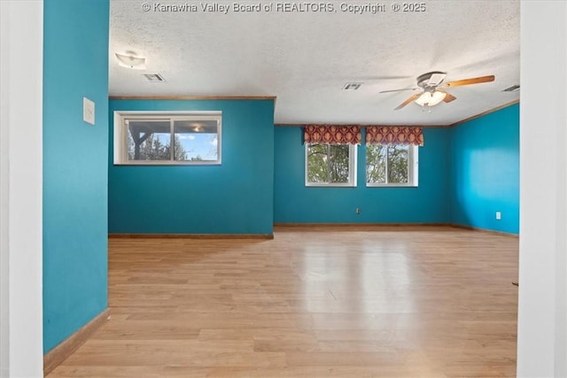141 Wedgewood Rd, Ravenswood, WV 26164 - unfurnished room featuring visible vents, baseboards, ceiling fan, a textured ceiling, and wood finished floors