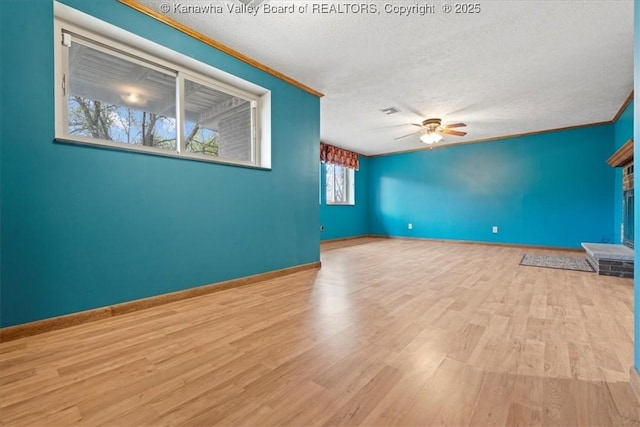 141 Wedgewood Rd, Ravenswood, WV 26164 - empty room featuring ceiling fan, a textured ceiling, ornamental molding, wood finished floors, and baseboards