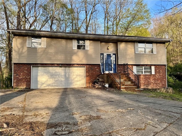 109 Cedar Ln, Saint Albans, WV 25177 - raised ranch with an attached garage, aphalt driveway, and brick siding