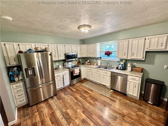 109 Cedar Ln, Saint Albans, WV 25177 - kitchen with dark wood-type flooring, a textured ceiling, appliances with stainless steel finishes, and a sink