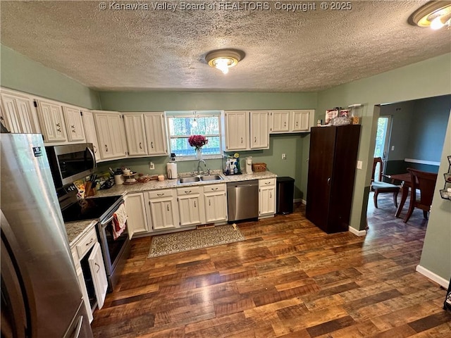 109 Cedar Ln, Saint Albans, WV 25177 - kitchen with a textured ceiling, appliances with stainless steel finishes, dark wood-style floors, and a sink