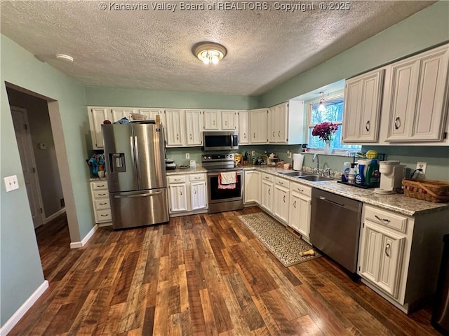 109 Cedar Ln, Saint Albans, WV 25177 - kitchen featuring stainless steel appliances, a sink, a textured ceiling, dark wood finished floors, and baseboards