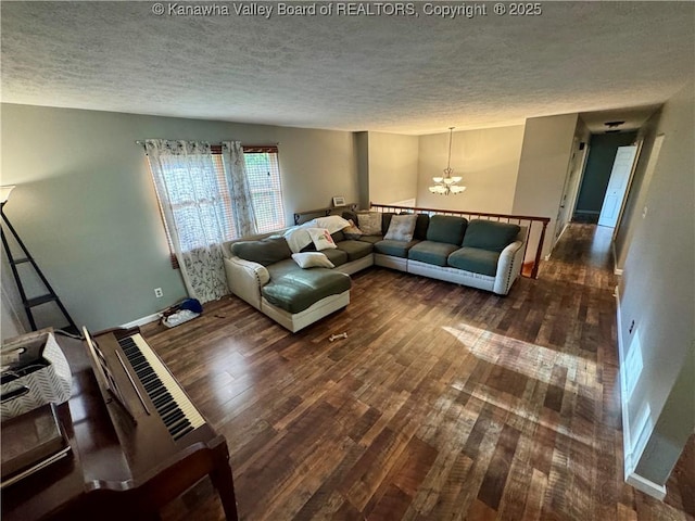 109 Cedar Ln, Saint Albans, WV 25177 - living area with a chandelier, wood finished floors, a textured ceiling, and baseboards