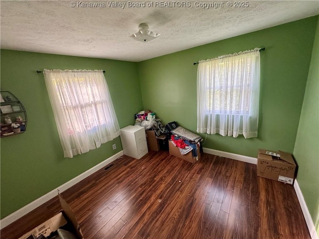 109 Cedar Ln, Saint Albans, WV 25177 - unfurnished bedroom featuring baseboards, a textured ceiling, hardwood / wood-style flooring, and visible vents