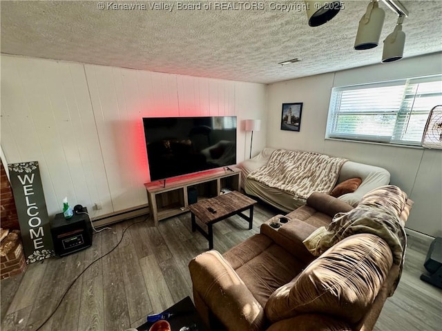 109 Cedar Ln, Saint Albans, WV 25177 - living area featuring baseboard heating, wood finished floors, and a textured ceiling