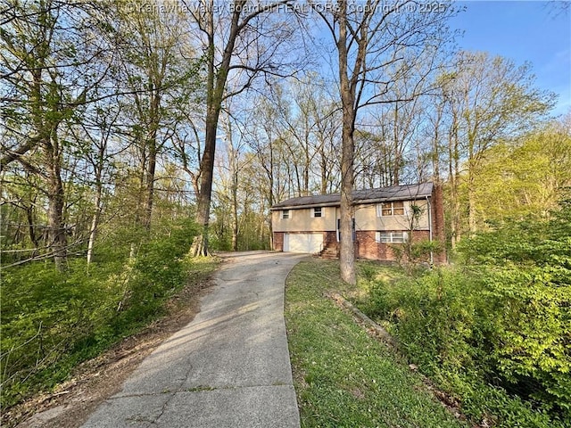 109 Cedar Ln, Saint Albans, WV 25177 - view of front of house featuring driveway, brick siding, and stucco siding
