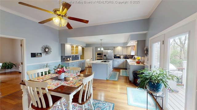 83 Lakeview Dr, Nitro, WV 25143 - dining room featuring light wood-style flooring, a ceiling fan, and ornamental molding