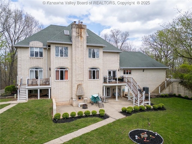 83 Lakeview Dr, Nitro, WV 25143 - back of property featuring a chimney, stairway, a deck, a patio, and an outdoor fire pit