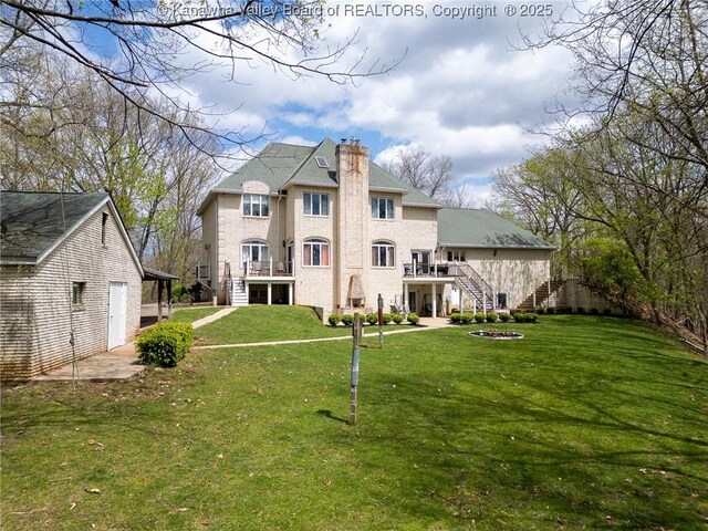 83 Lakeview Dr, Nitro, WV 25143 - rear view of property featuring stairway, a lawn, a chimney, and a wooden deck