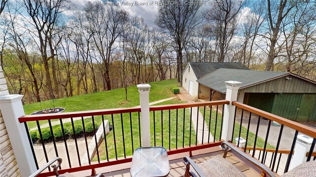 83 Lakeview Dr, Nitro, WV 25143 - wooden deck featuring an outbuilding, an outdoor fire pit, and a lawn