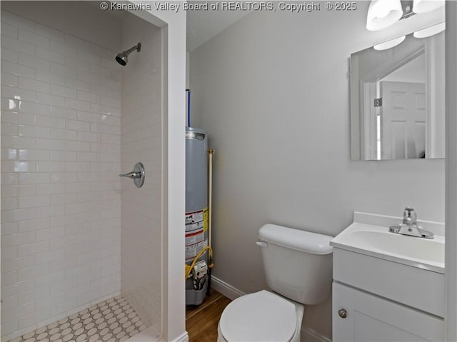bathroom with water heater, a shower stall, toilet, and vanity