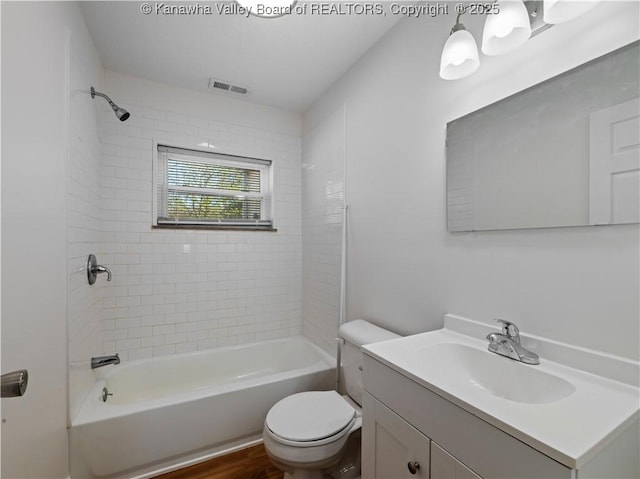 full bath featuring toilet, vanity, shower / bath combination, and visible vents