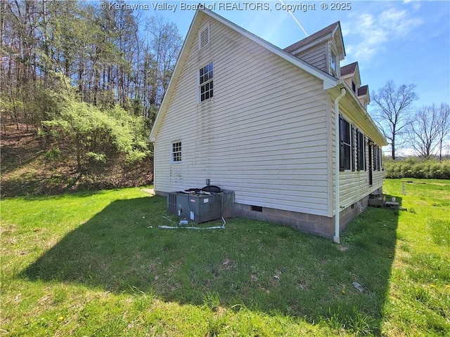 view of home's exterior with a lawn and crawl space