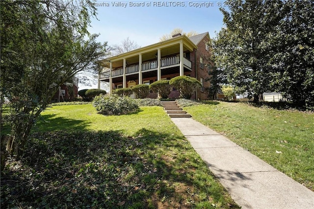1055 Highland Dr, Saint Albans, WV 25177 - view of front of property with a balcony, a front yard, and brick siding