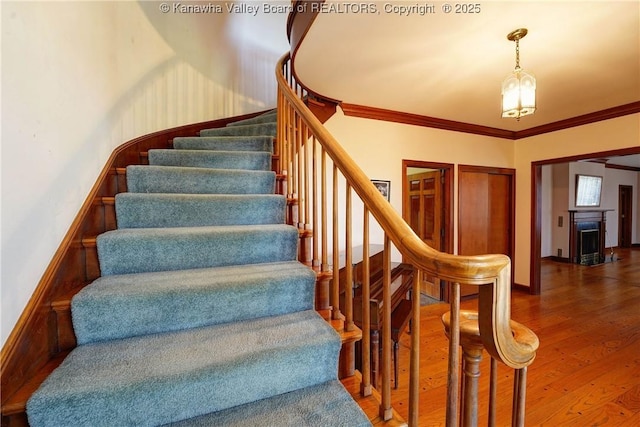 1055 Highland Dr, Saint Albans, WV 25177 - stairway featuring baseboards, wood finished floors, and ornamental molding