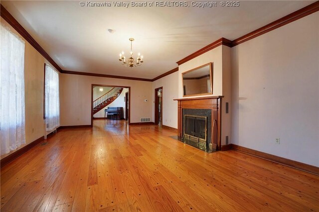 1055 Highland Dr, Saint Albans, WV 25177 - unfurnished living room featuring visible vents, a chandelier, a high end fireplace, stairway, and ornamental molding