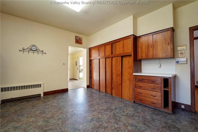 1055 Highland Dr, Saint Albans, WV 25177 - kitchen with radiator heating unit, brown cabinetry, light countertops, and baseboards