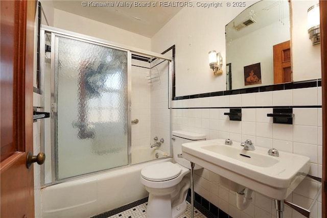 1055 Highland Dr, Saint Albans, WV 25177 - bathroom with shower / bath combination with glass door, tile walls, visible vents, and toilet