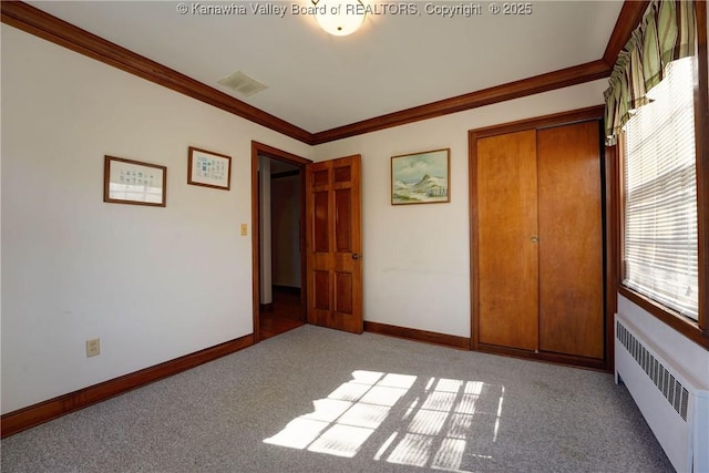 1055 Highland Dr, Saint Albans, WV 25177 - unfurnished bedroom with radiator heating unit, crown molding, baseboards, and light carpet