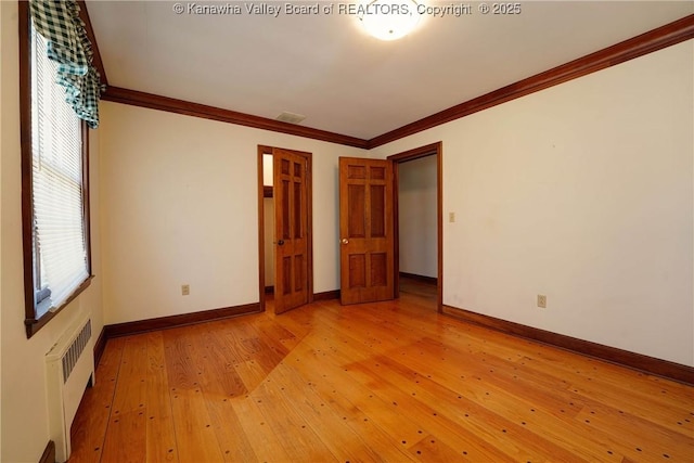 1055 Highland Dr, Saint Albans, WV 25177 - unfurnished bedroom with light wood-type flooring, baseboards, visible vents, radiator heating unit, and ornamental molding