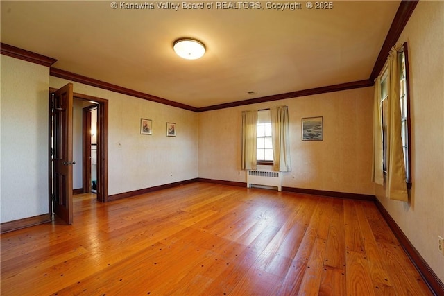 1055 Highland Dr, Saint Albans, WV 25177 - spare room with hardwood / wood-style flooring, baseboards, radiator heating unit, and crown molding