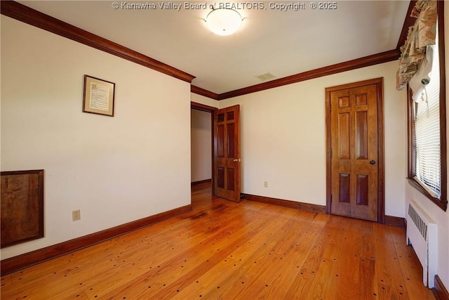 1055 Highland Dr, Saint Albans, WV 25177 - spare room with radiator, crown molding, visible vents, and light wood-type flooring