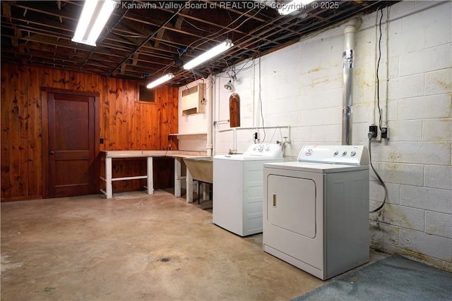 1055 Highland Dr, Saint Albans, WV 25177 - laundry room featuring concrete block wall, wood walls, independent washer and dryer, and laundry area