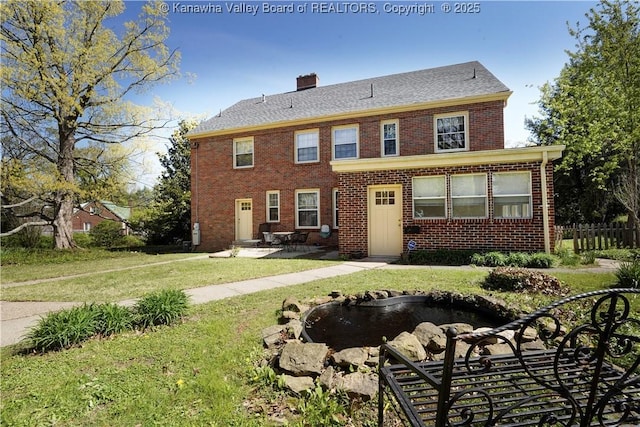 1055 Highland Dr, Saint Albans, WV 25177 - view of front of home with a small pond, a patio area, fence, a front yard, and brick siding