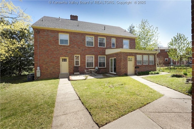 1055 Highland Dr, Saint Albans, WV 25177 - rear view of house featuring a lawn, brick siding, fence, and a patio
