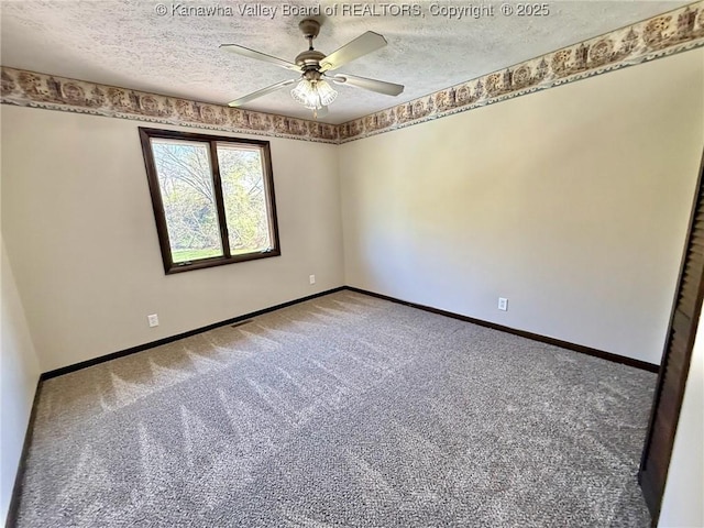 carpeted empty room featuring a textured ceiling, a ceiling fan, and baseboards
