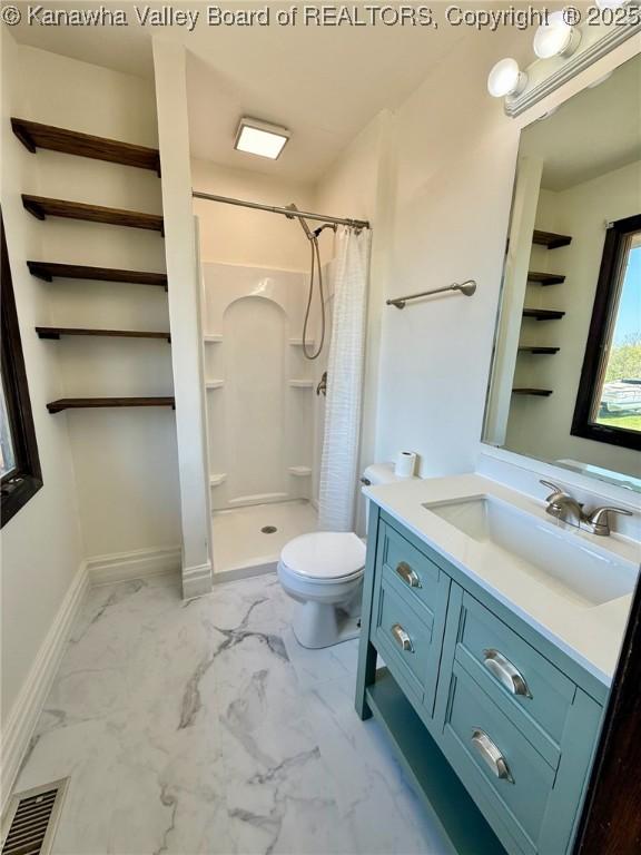 bathroom featuring a stall shower, vanity, marble finish floor, toilet, and visible vents