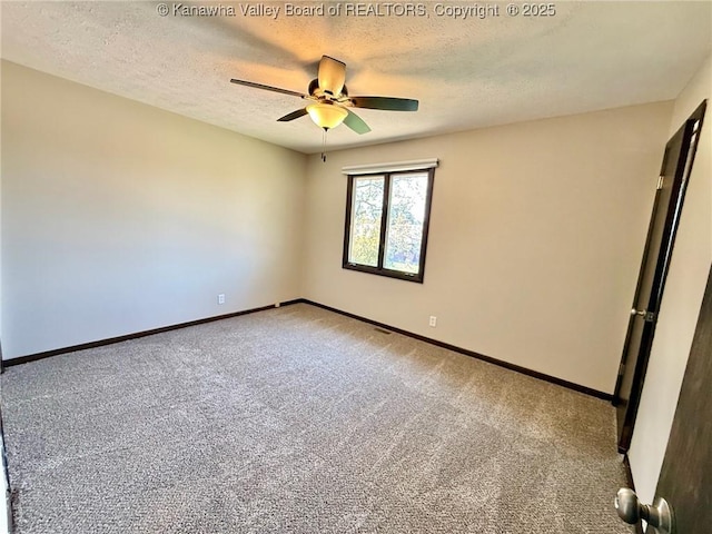 unfurnished room with a textured ceiling, carpet flooring, baseboards, and ceiling fan