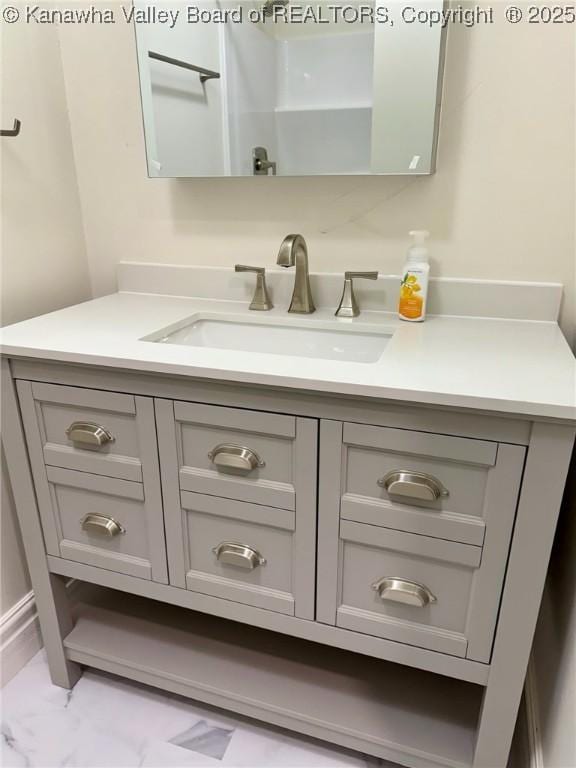 bathroom with marble finish floor and vanity