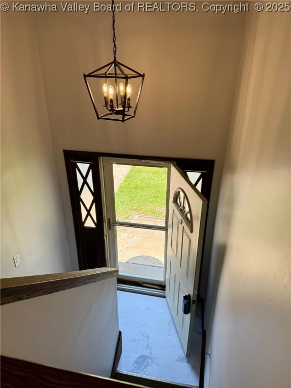 entryway with a notable chandelier