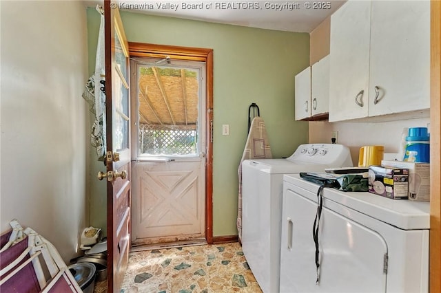 laundry room with baseboards, independent washer and dryer, and cabinet space