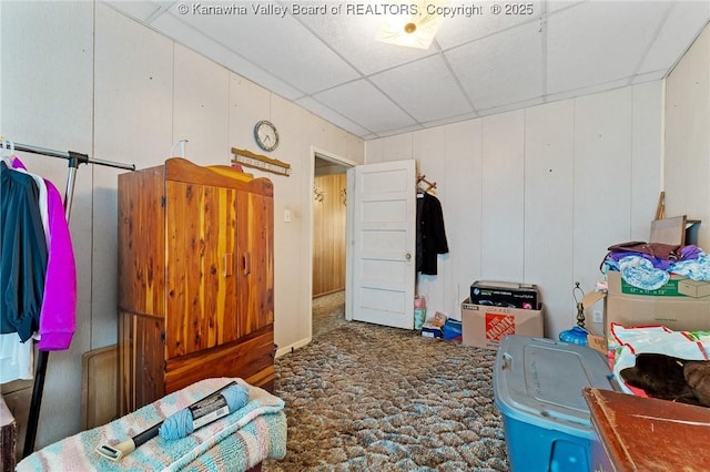 carpeted bedroom with a drop ceiling