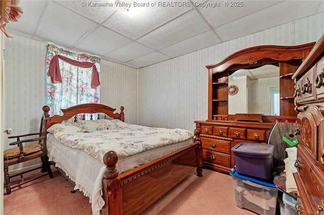 bedroom featuring carpet floors, wallpapered walls, and a paneled ceiling