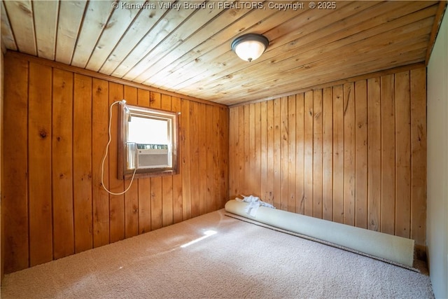 unfurnished room featuring wooden walls, carpet, and wood ceiling