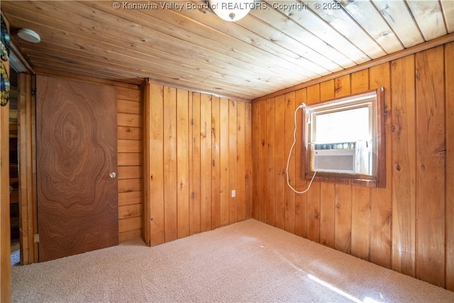 spare room featuring wooden ceiling, wood walls, carpet flooring, and cooling unit
